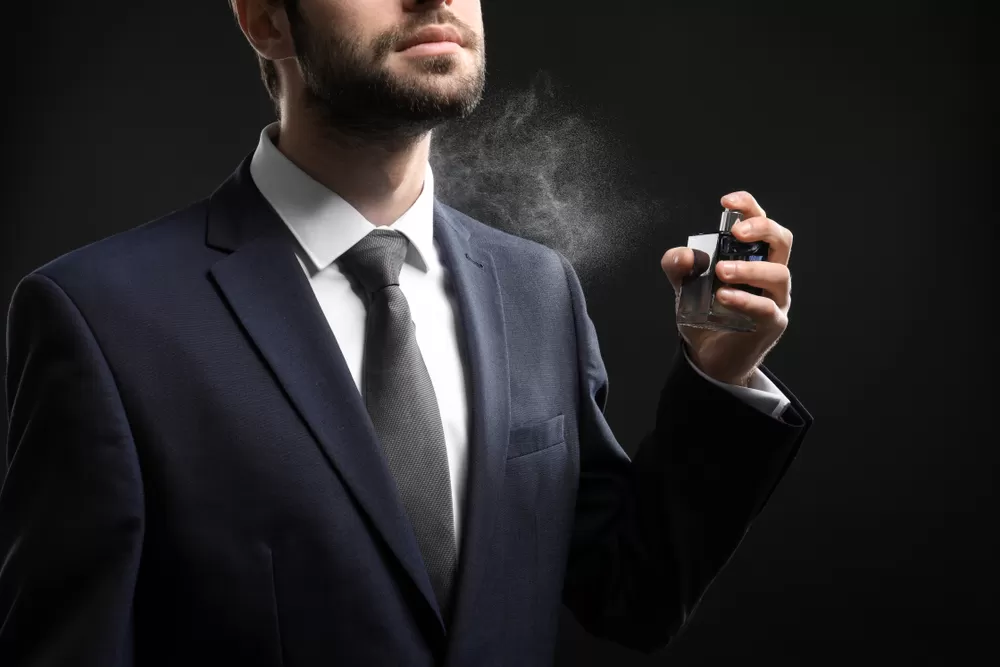 Handsome,Man,In,Formal,Suit,And,With,Bottle,Of,Perfume