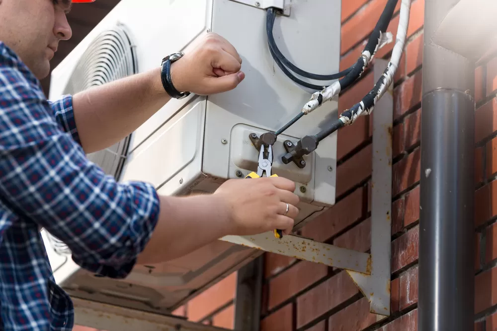 Male,Technician,Repairing,Outdoor,Air,Conditioner,Unit